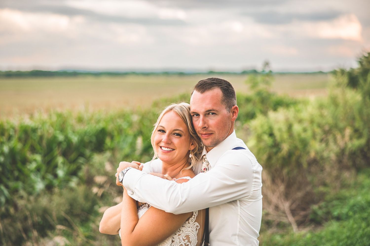 Candid wedding moments captured in a rustic outdoor farm setting.