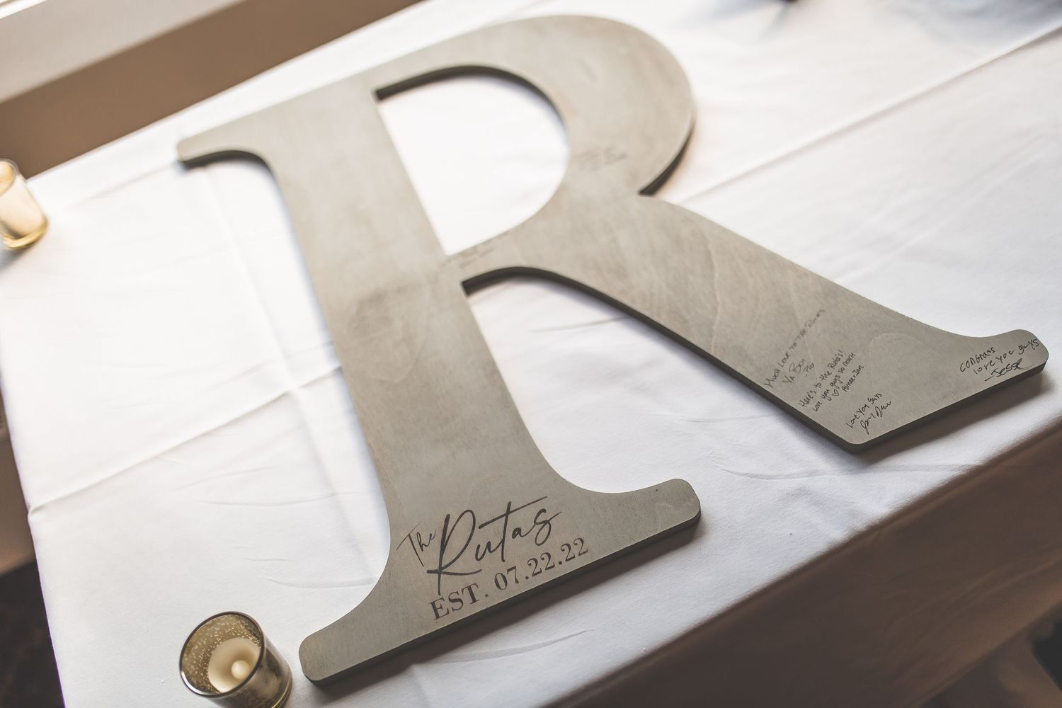 Wedding stationery and paper goods arranged on a white surface.