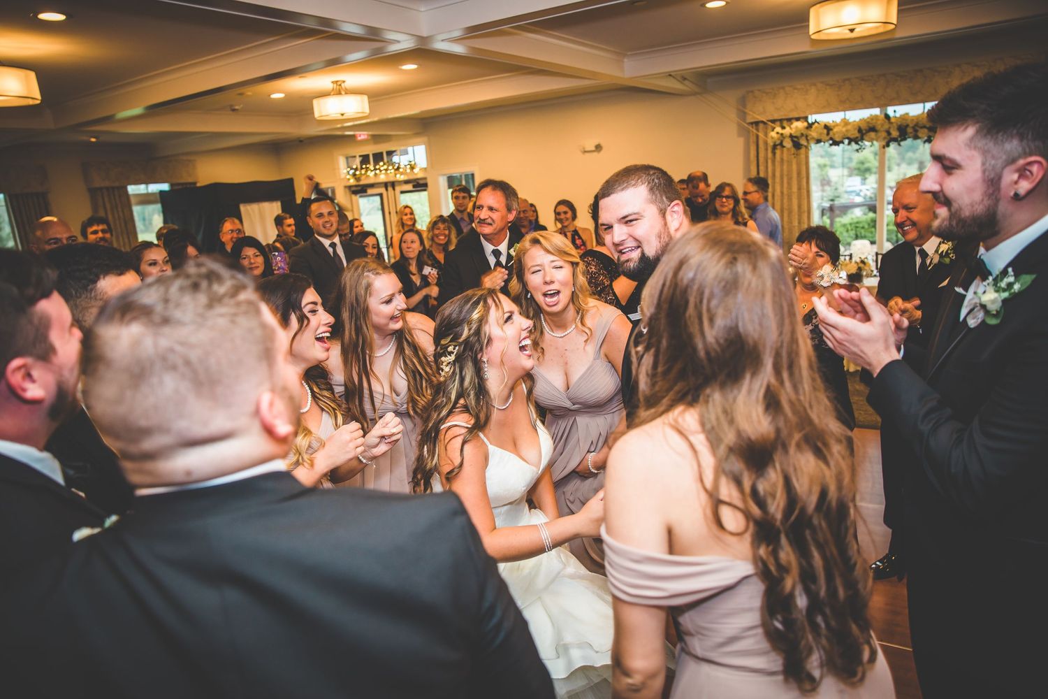 Wedding guests dancing and celebrating together at a lively reception party.