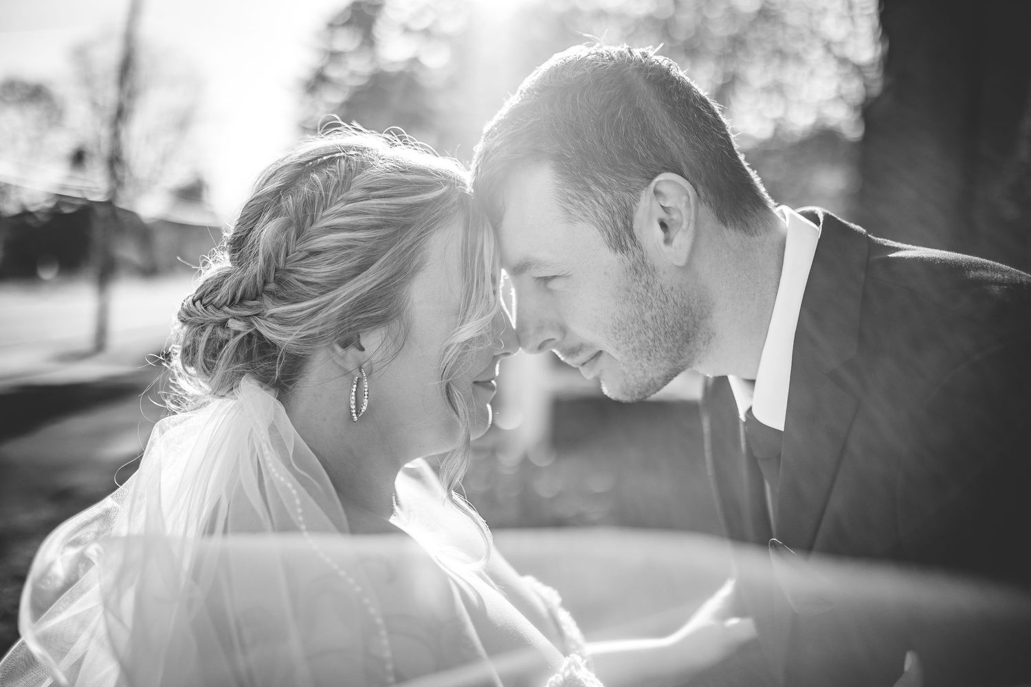 Artistic black and white wedding portraits with dramatic lighting.