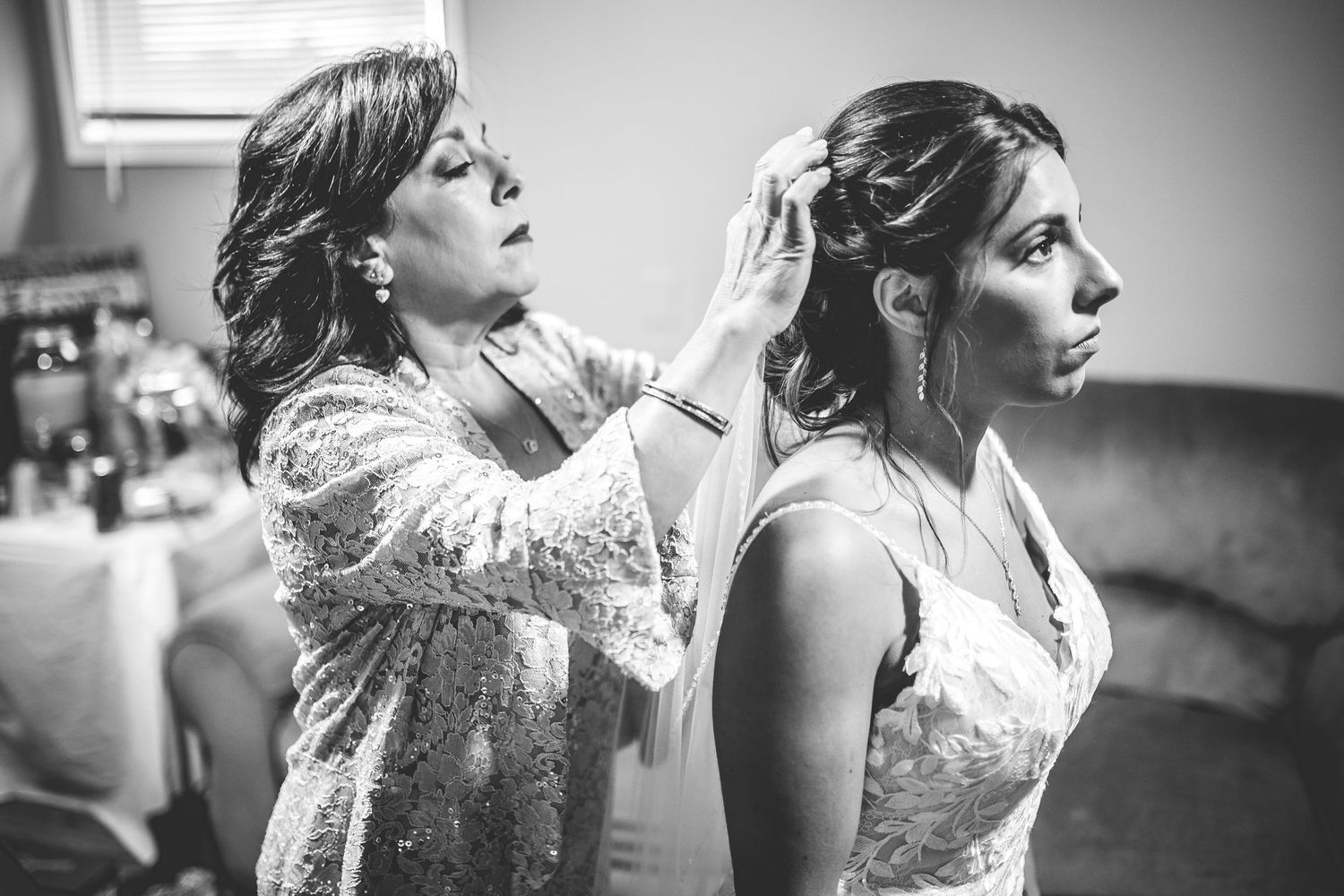 Black and white candid photos of wedding preparation moments.