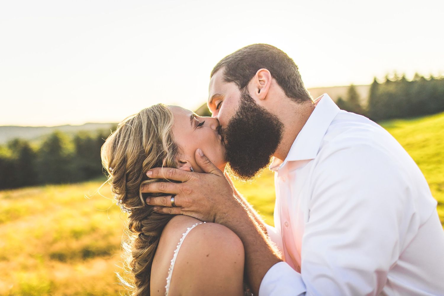 Intimate wedding portraits captured during golden hour in nature.