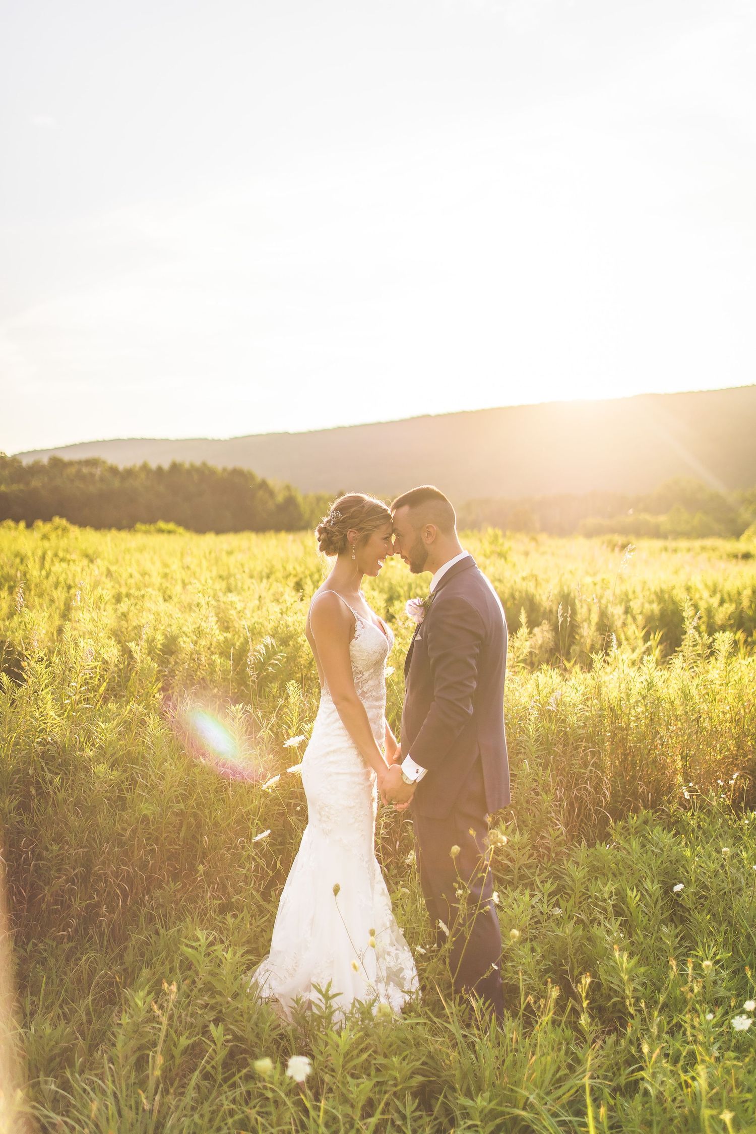 Golden sunset wedding portrait in a wildflower meadow.