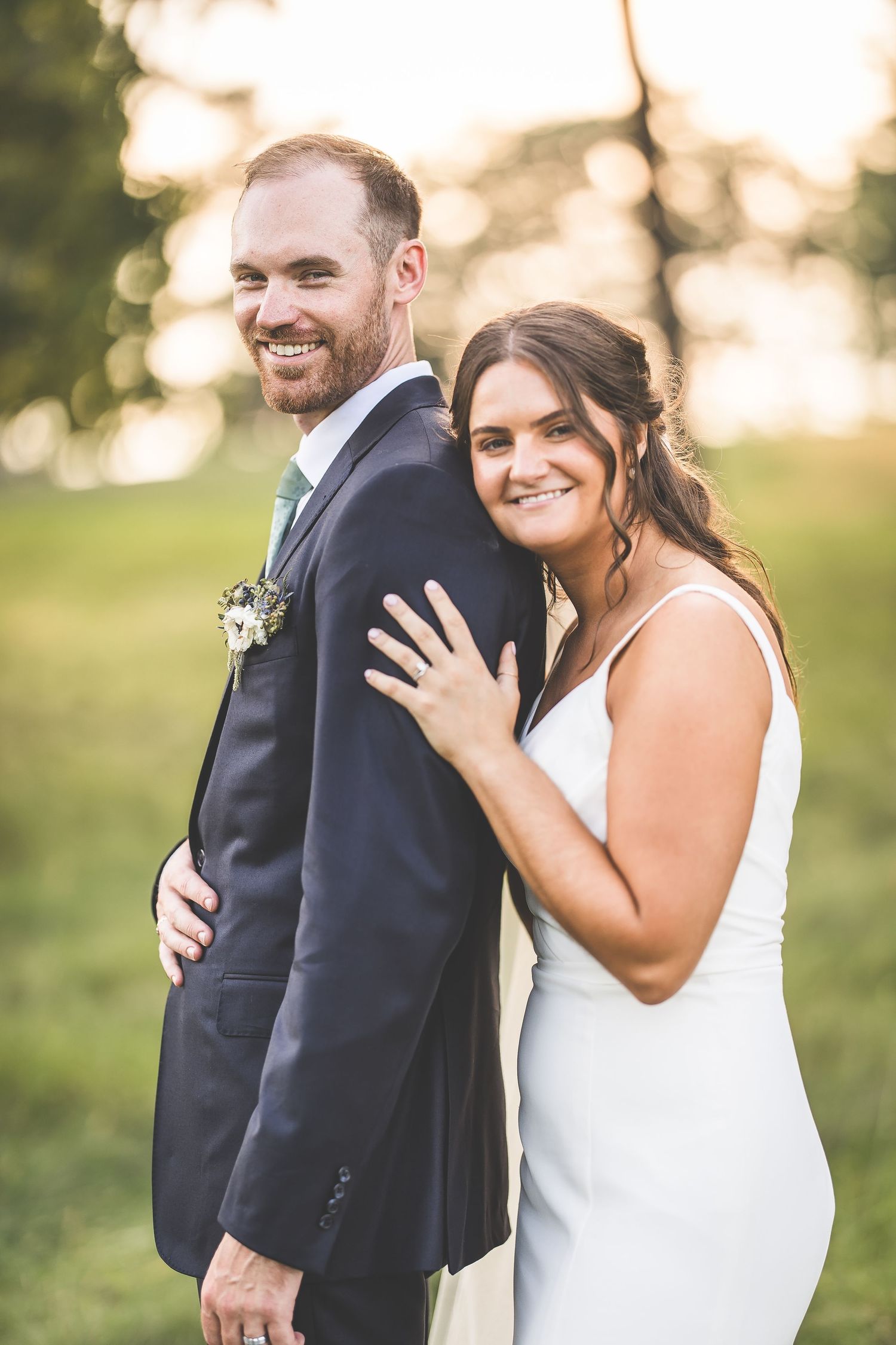Candid wedding portraits showing joyful laughter and embraces in outdoor setting.