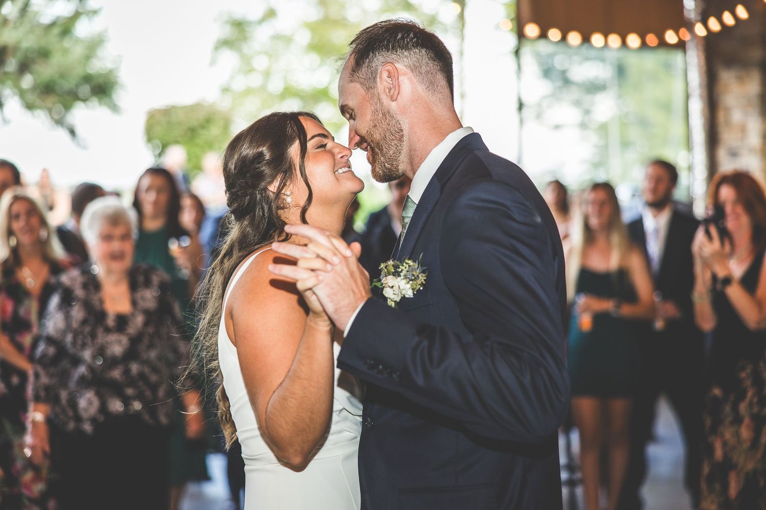 First dance moment at wedding reception with guests watching from the sides.