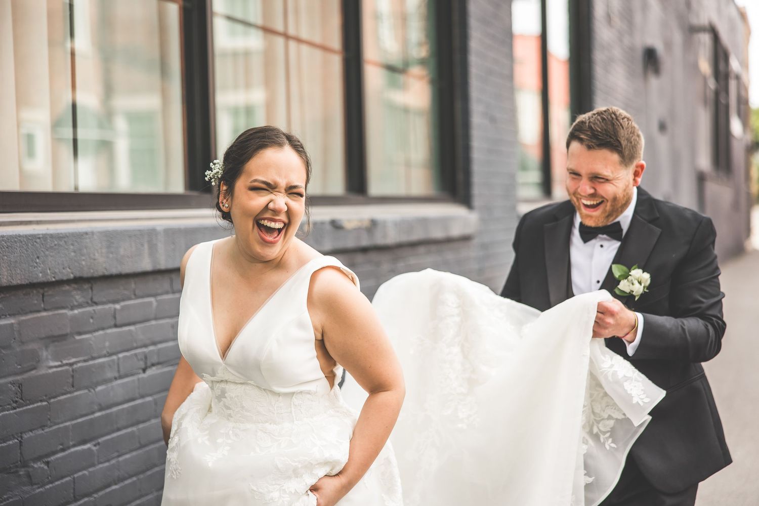 Joyful wedding celebration captured outside an industrial-style building.