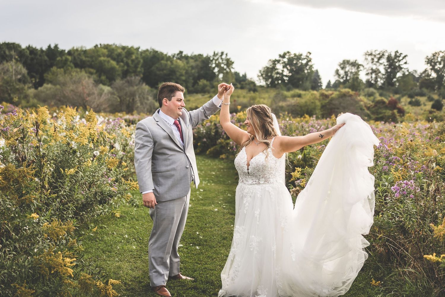Playful wedding photos taken in a blooming garden with natural light and vibrant flowers.