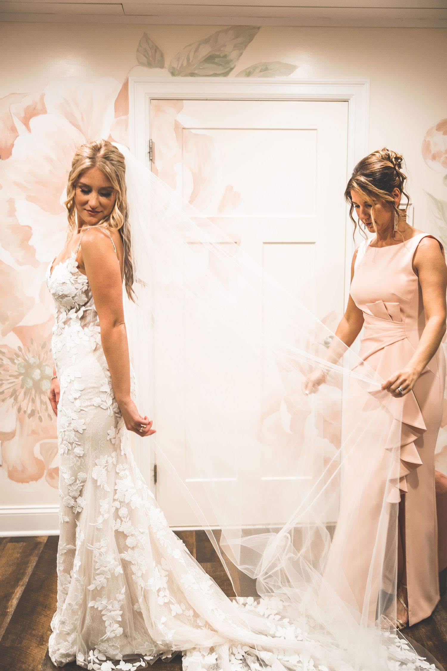 A series of intimate getting ready moments showing the delicate details of a white lace wedding dress and veil.