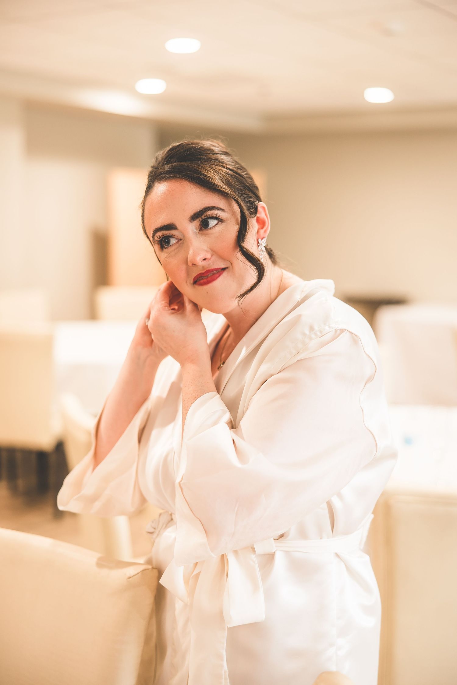 Getting ready scene with soft lighting and white robe.