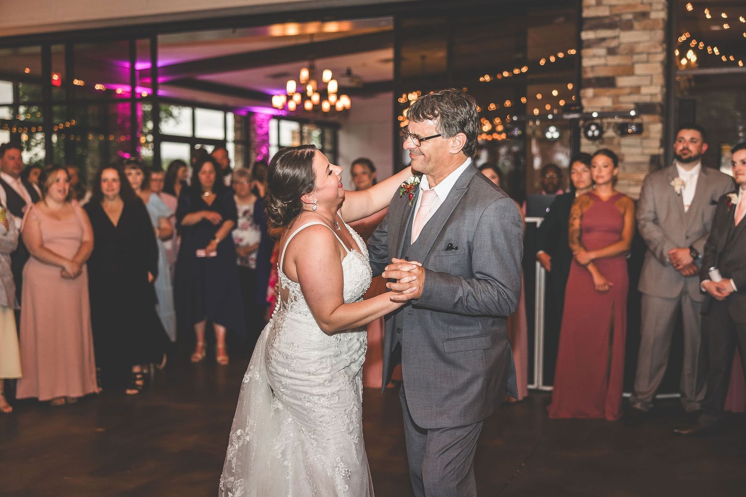 Wedding celebration in progress with ambient lighting and rustic stone decor.