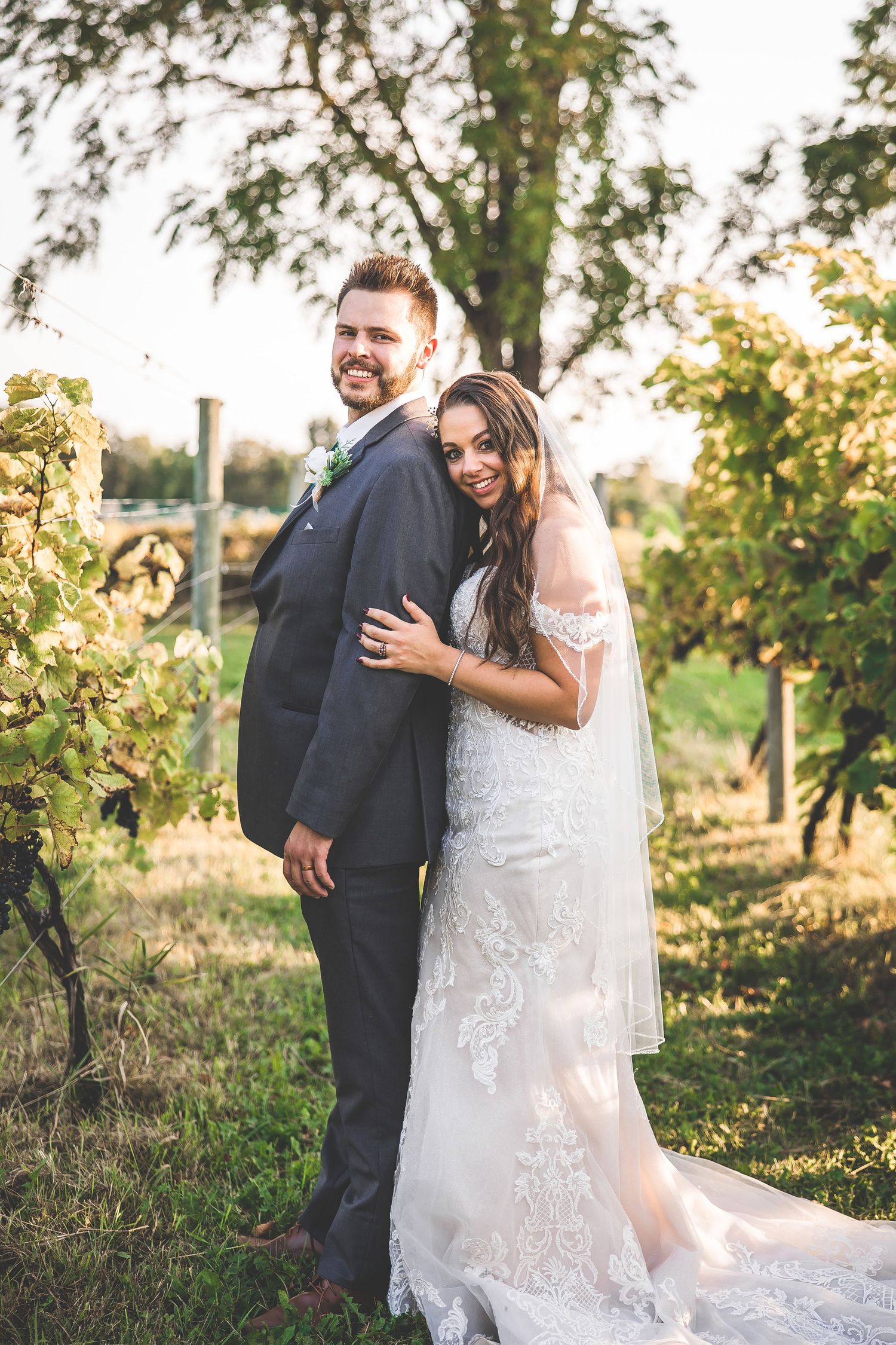 Joyful wedding portraits captured in natural outdoor setting during golden hour.