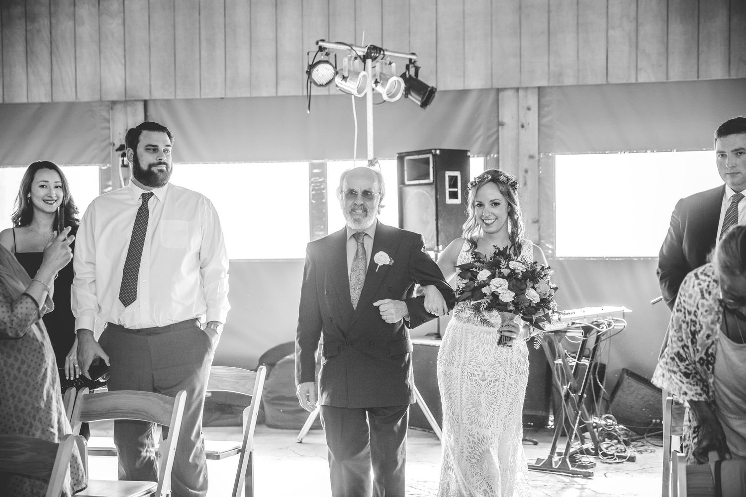 Black and white candid moments during indoor wedding ceremony.