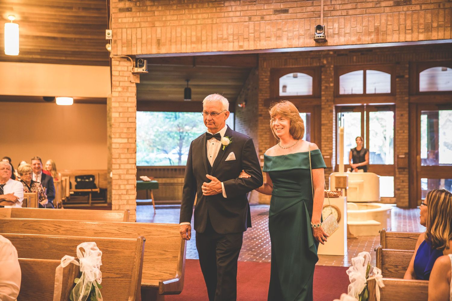 Interior of rustic wedding venue with exposed brick walls and warm lighting.