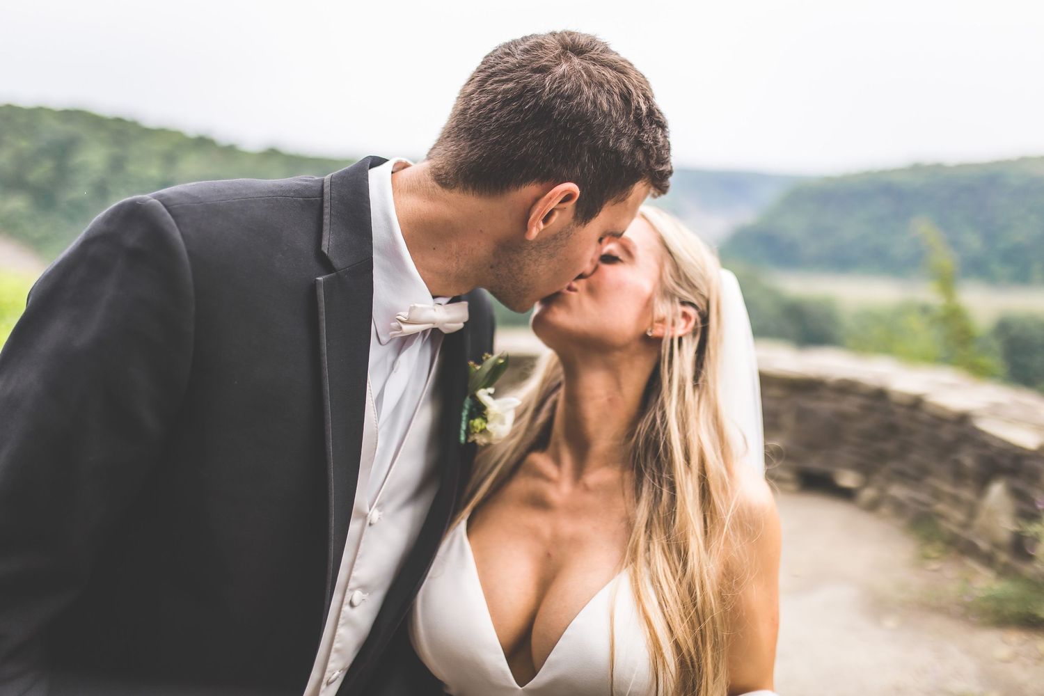 Wedding couple exchanges loving glances during outdoor mountain portrait session.