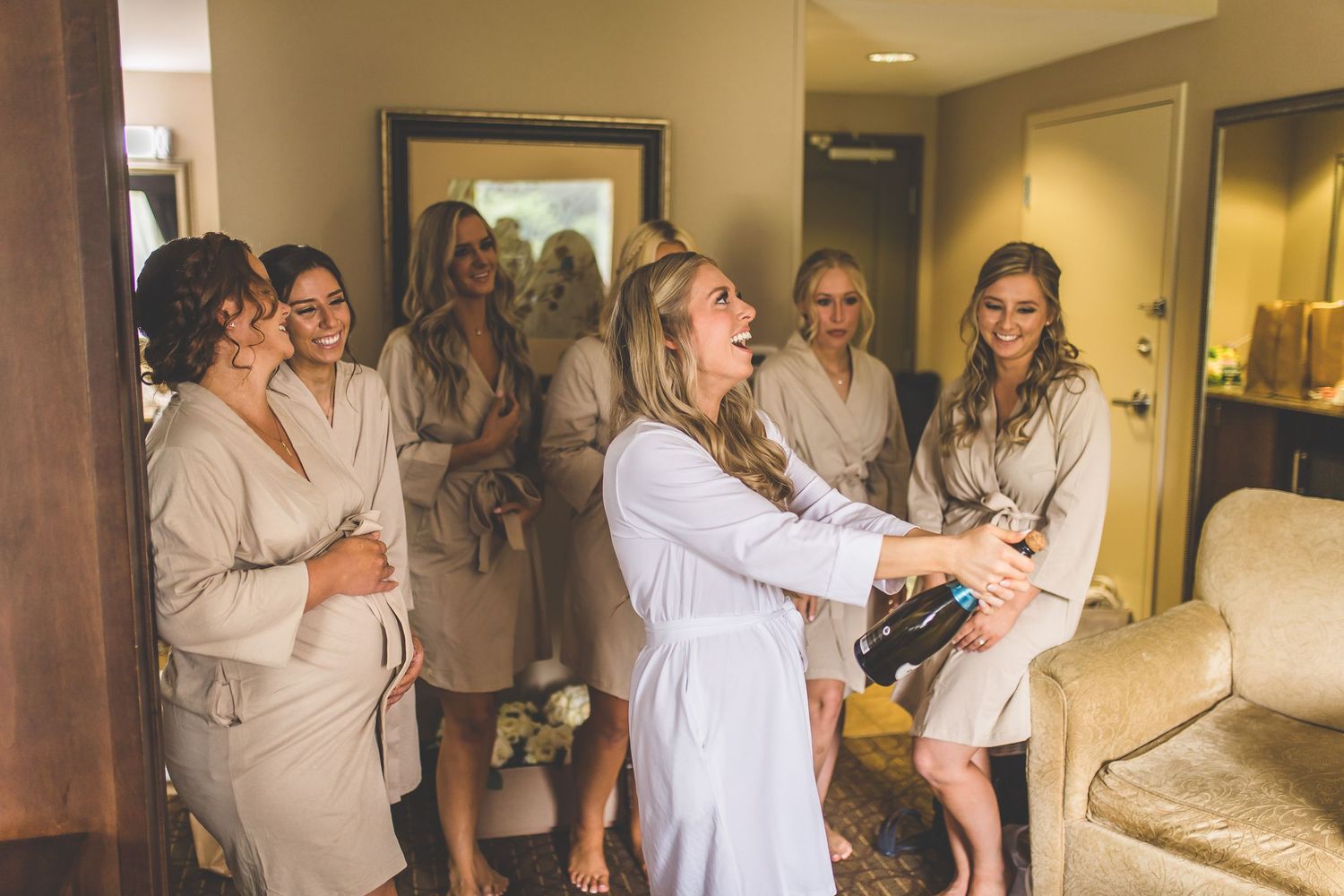 Candid pre-wedding preparation moments captured in a hotel suite.