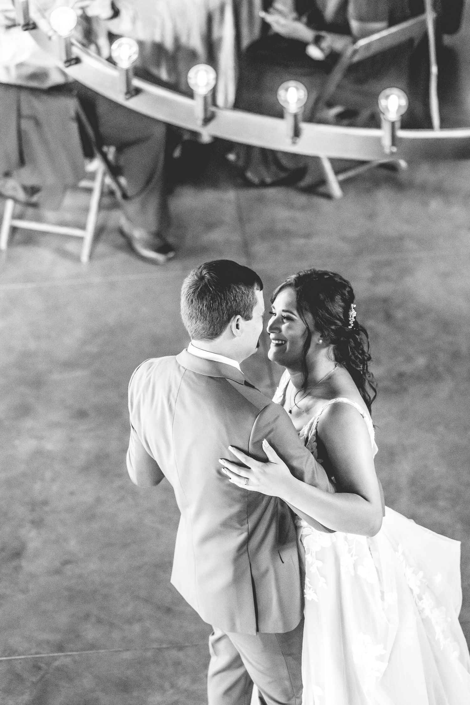 A tender dance moment captured in black and white at a wedding reception.