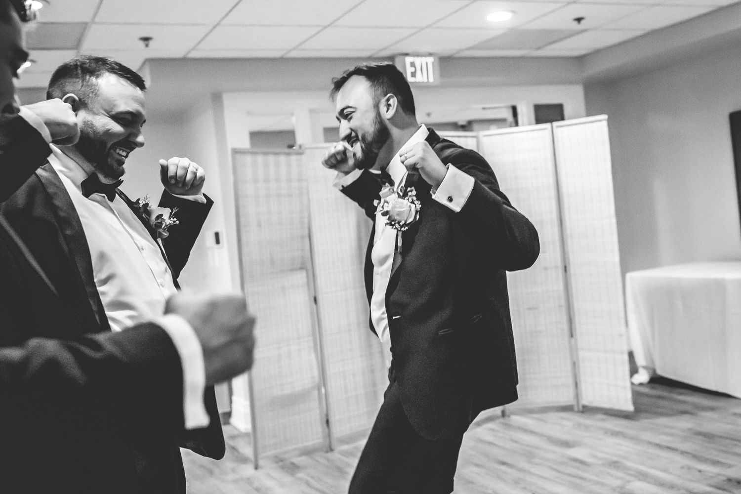 Black and white candid moments captured in indoor hallway setting.