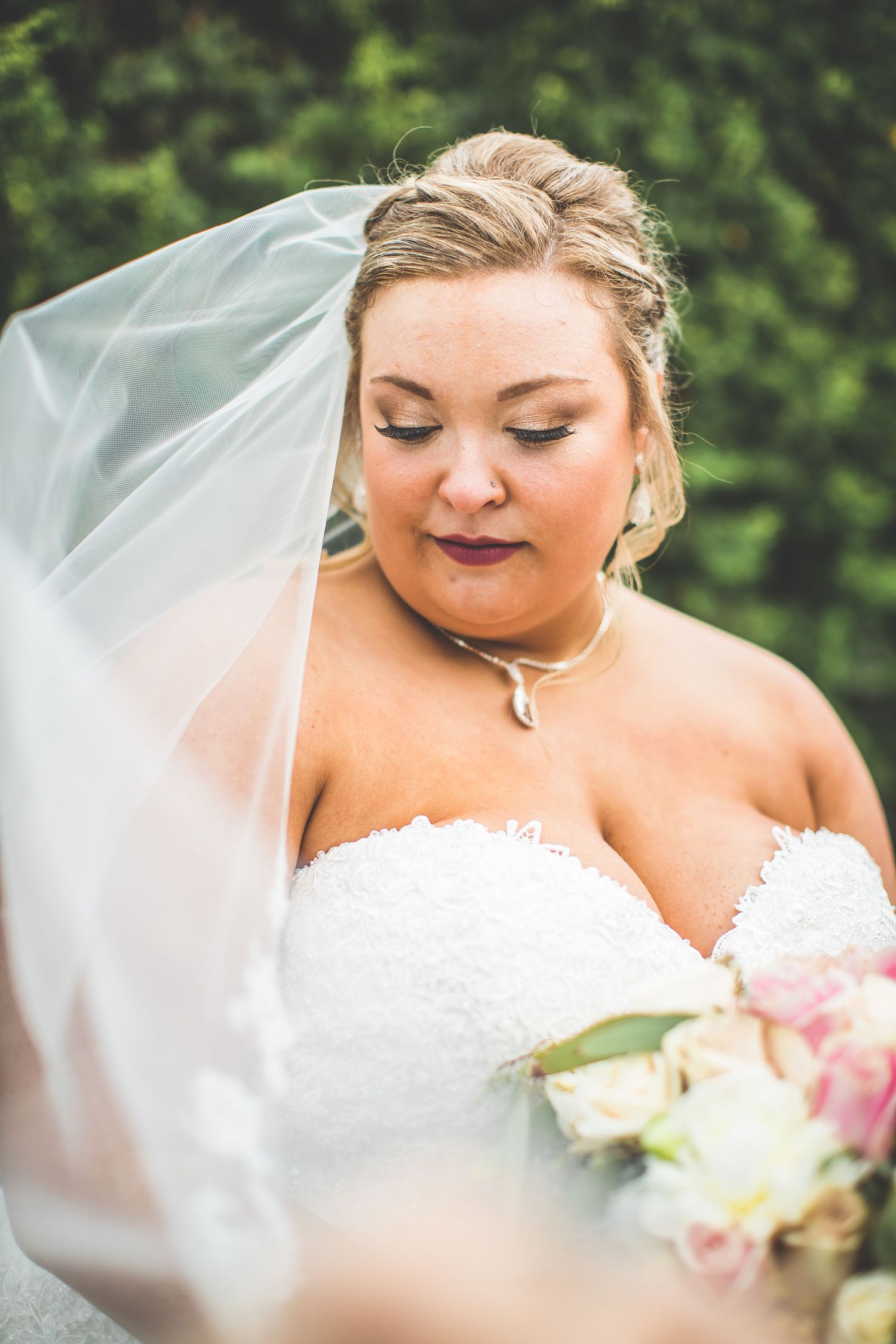 Close-up bridal portrait with delicate veil and soft makeup.