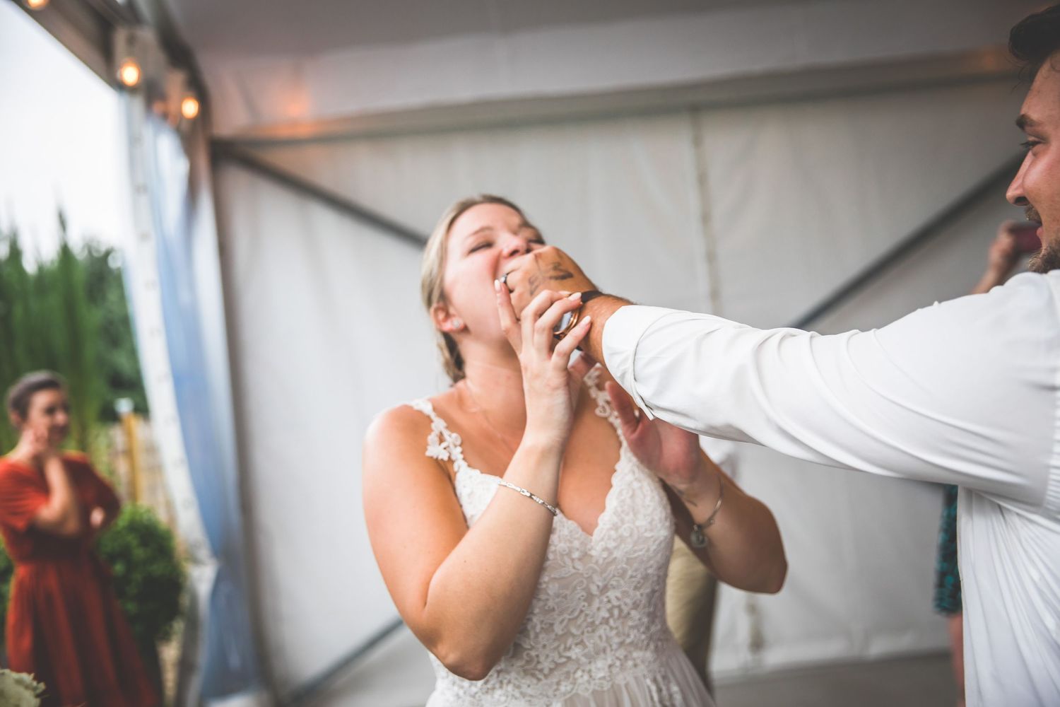 Couple sharing a romantic dance moment at an indoor wedding celebration.