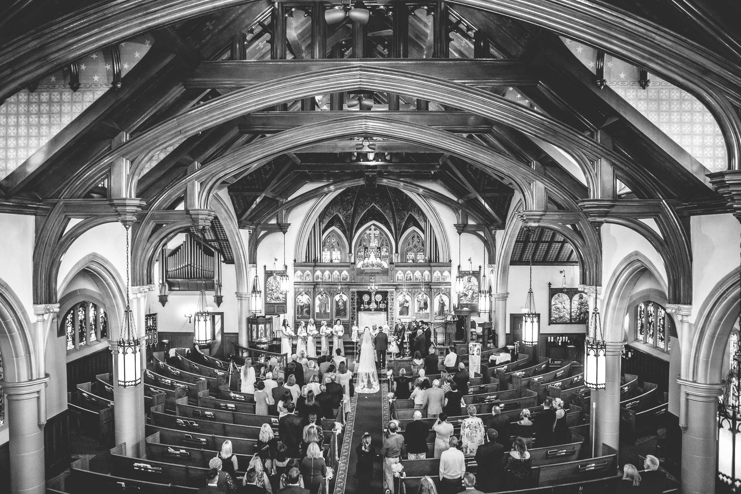 Architectural panorama of a church interior showing vaulted ceilings and gothic arches.