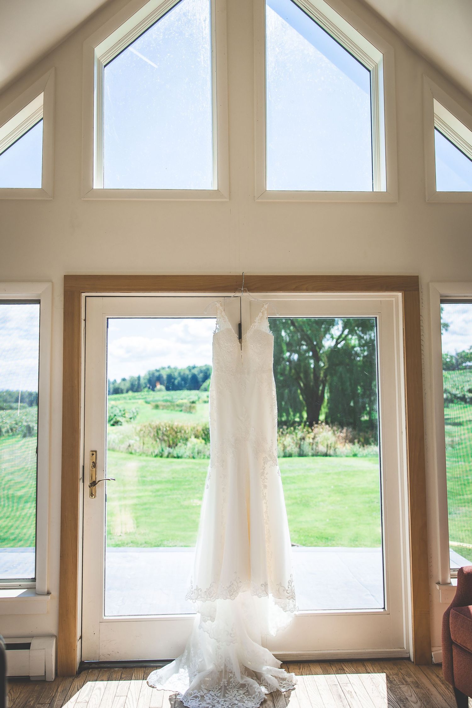 Elegant wedding venue interior with large windows overlooking scenic landscape.
