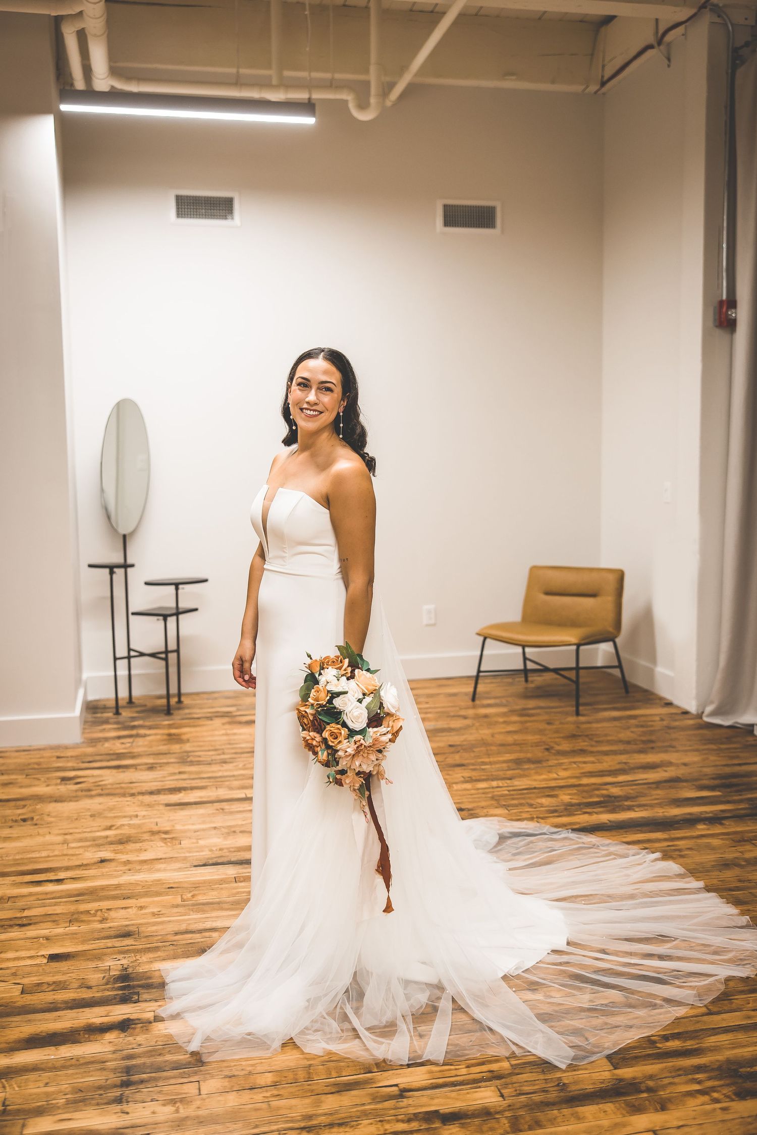 A sequence of joyful bridal portraits taken in a minimalist room with wooden floors and white walls.