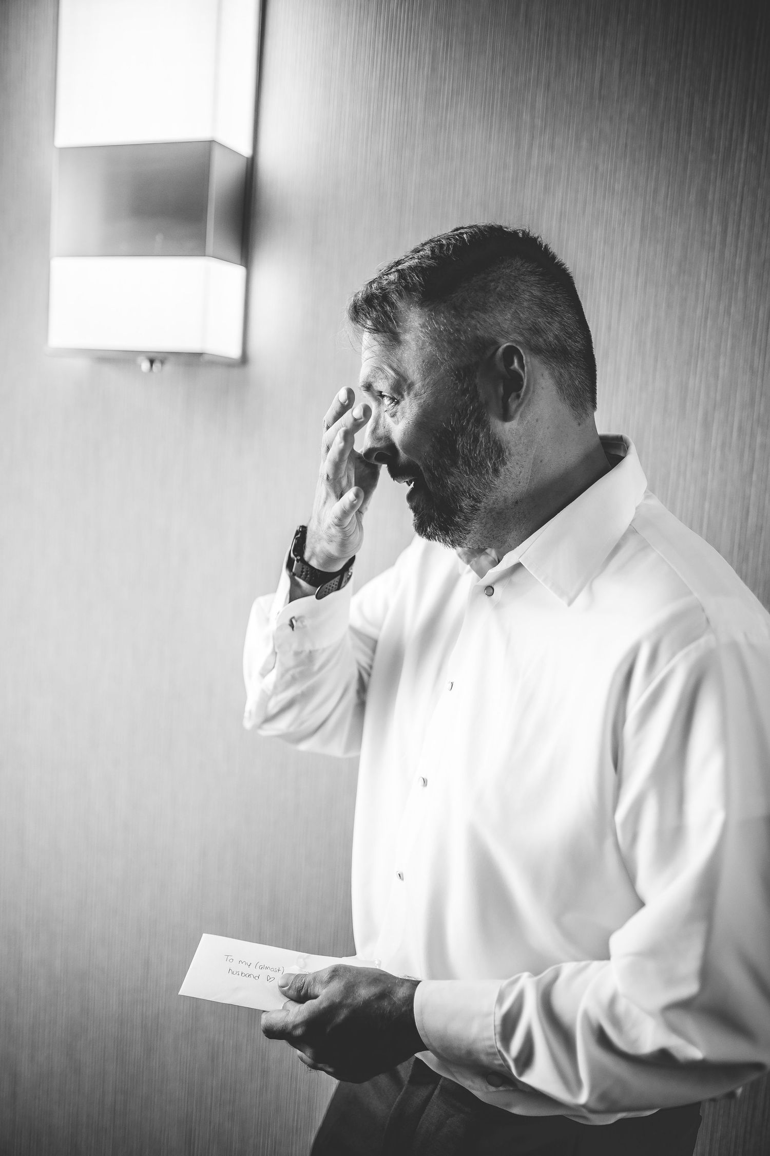 Black and white portrait series of person in white shirt reading emotional letter.