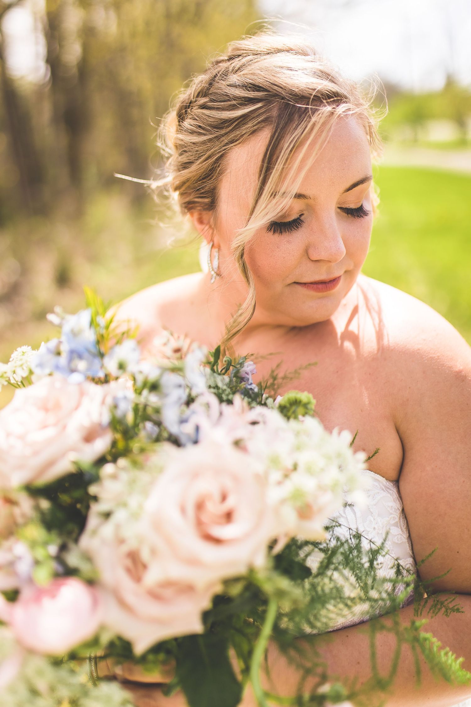 Close-up of delicate pink and white wedding bouquet with soft natural lighting.