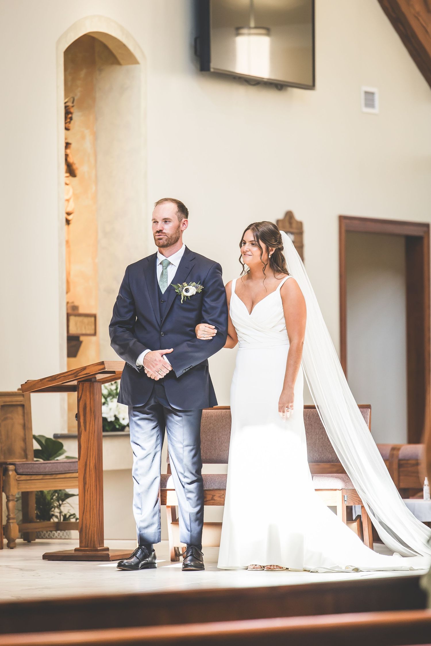 Wedding ceremony moments captured in a modern church sanctuary with wooden details.