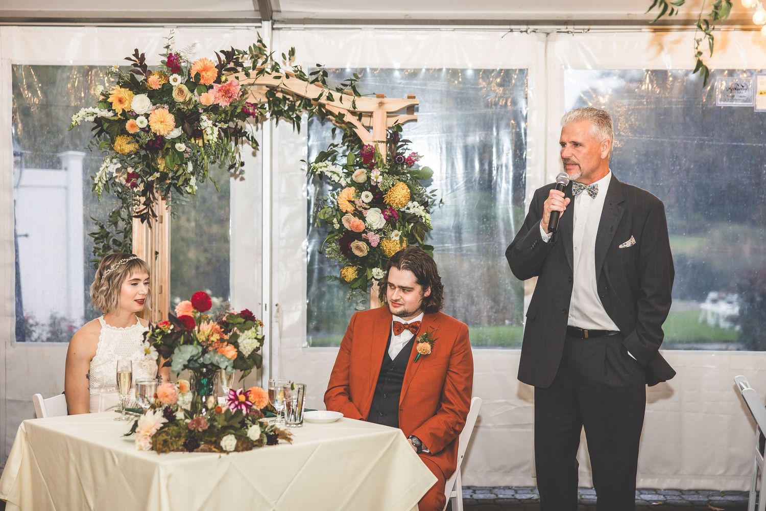 Wedding reception space with elegant lighting and floral arrangements.
