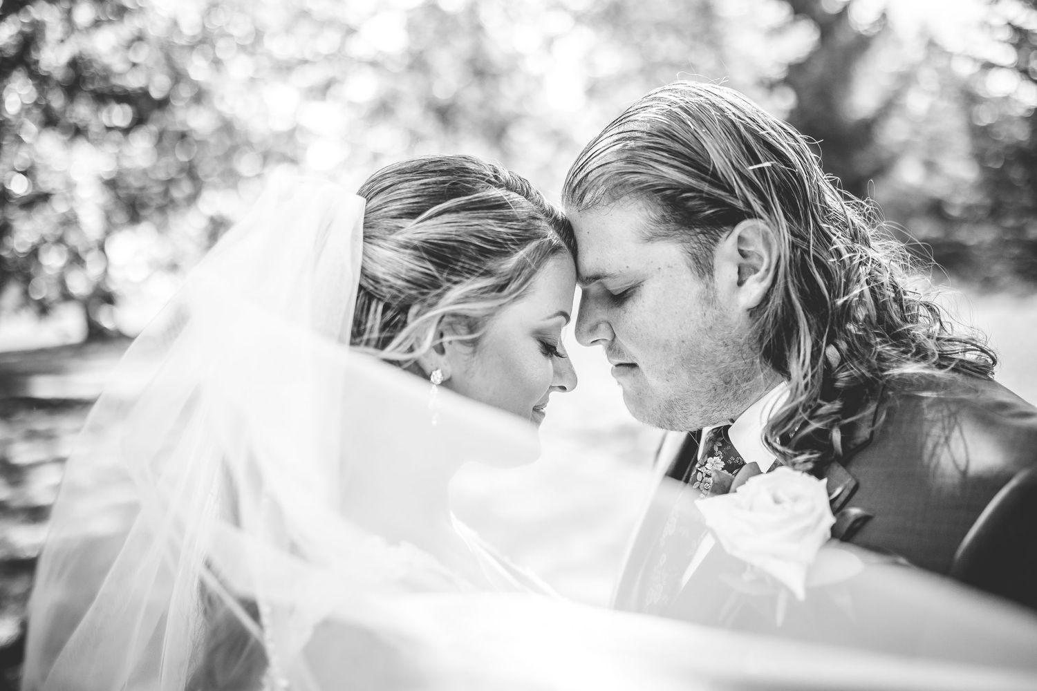 Series of romantic black and white close-up wedding kiss portraits.