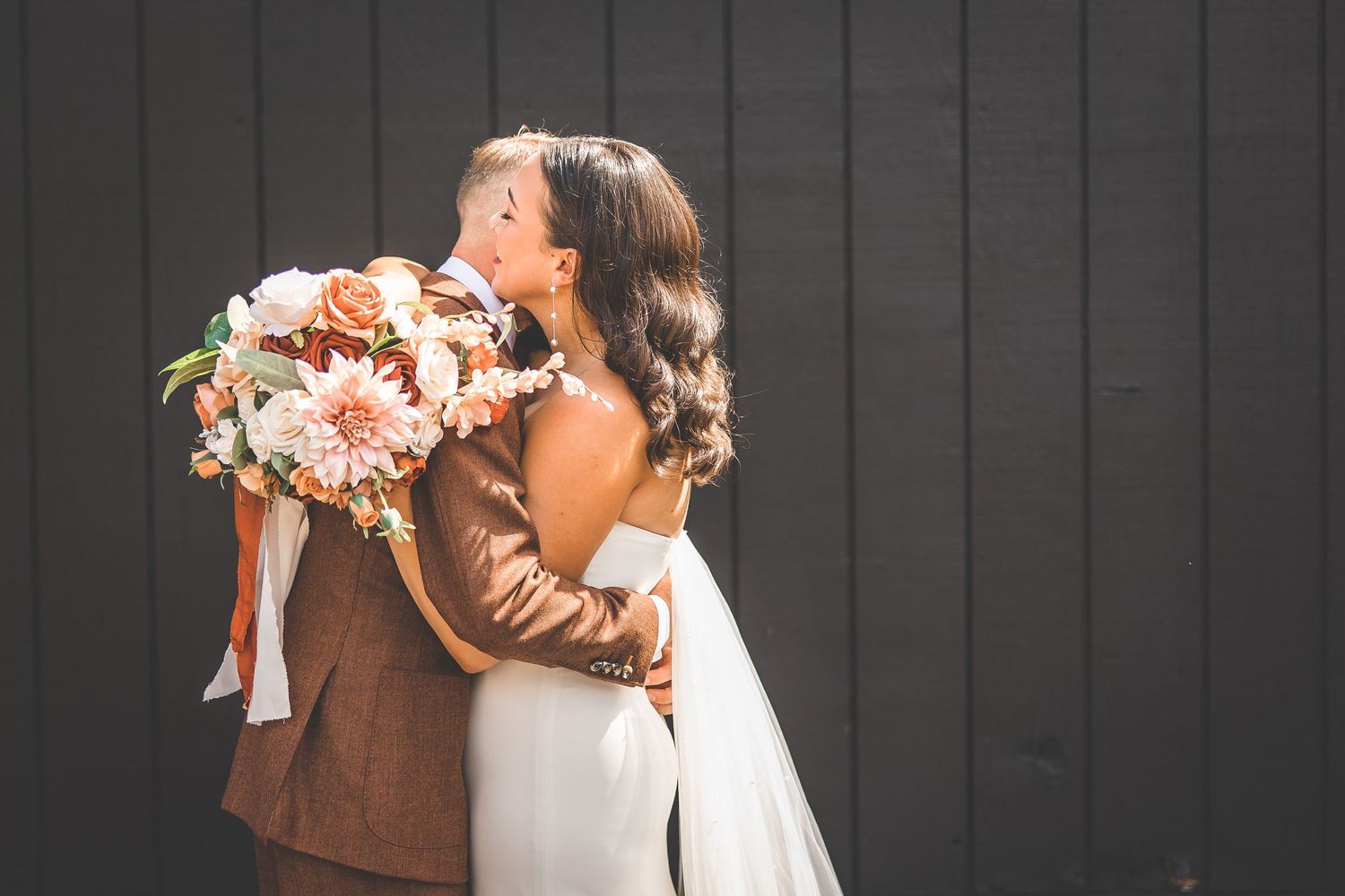 Intimate wedding photos showing tender moments against a dark wooden wall background.