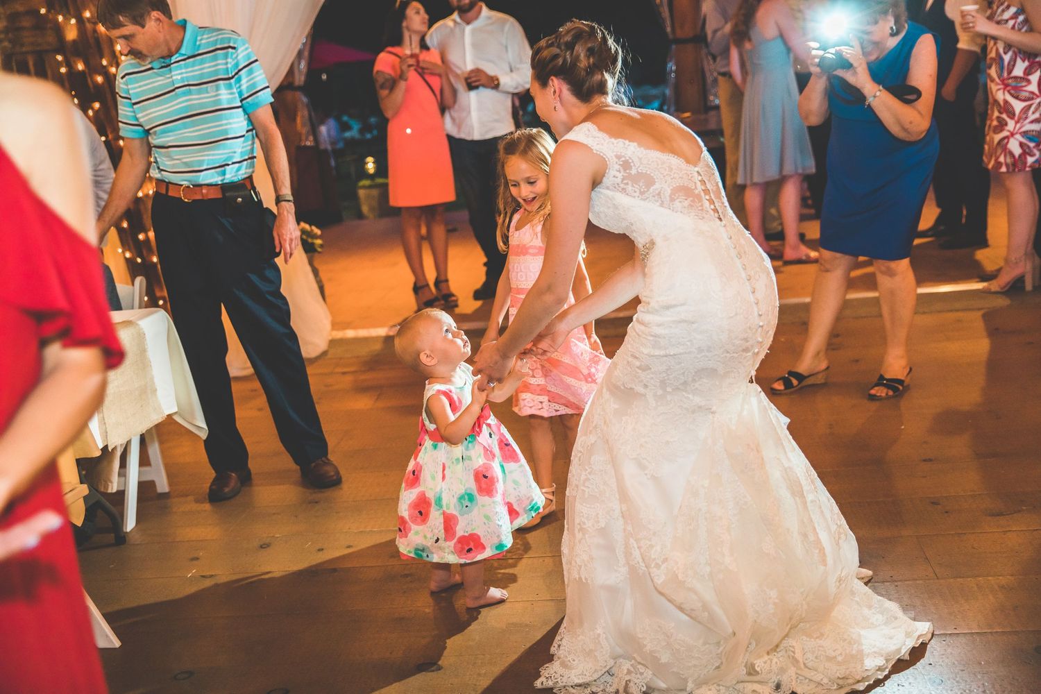 A wedding reception dance floor moment with guests watching the celebration.