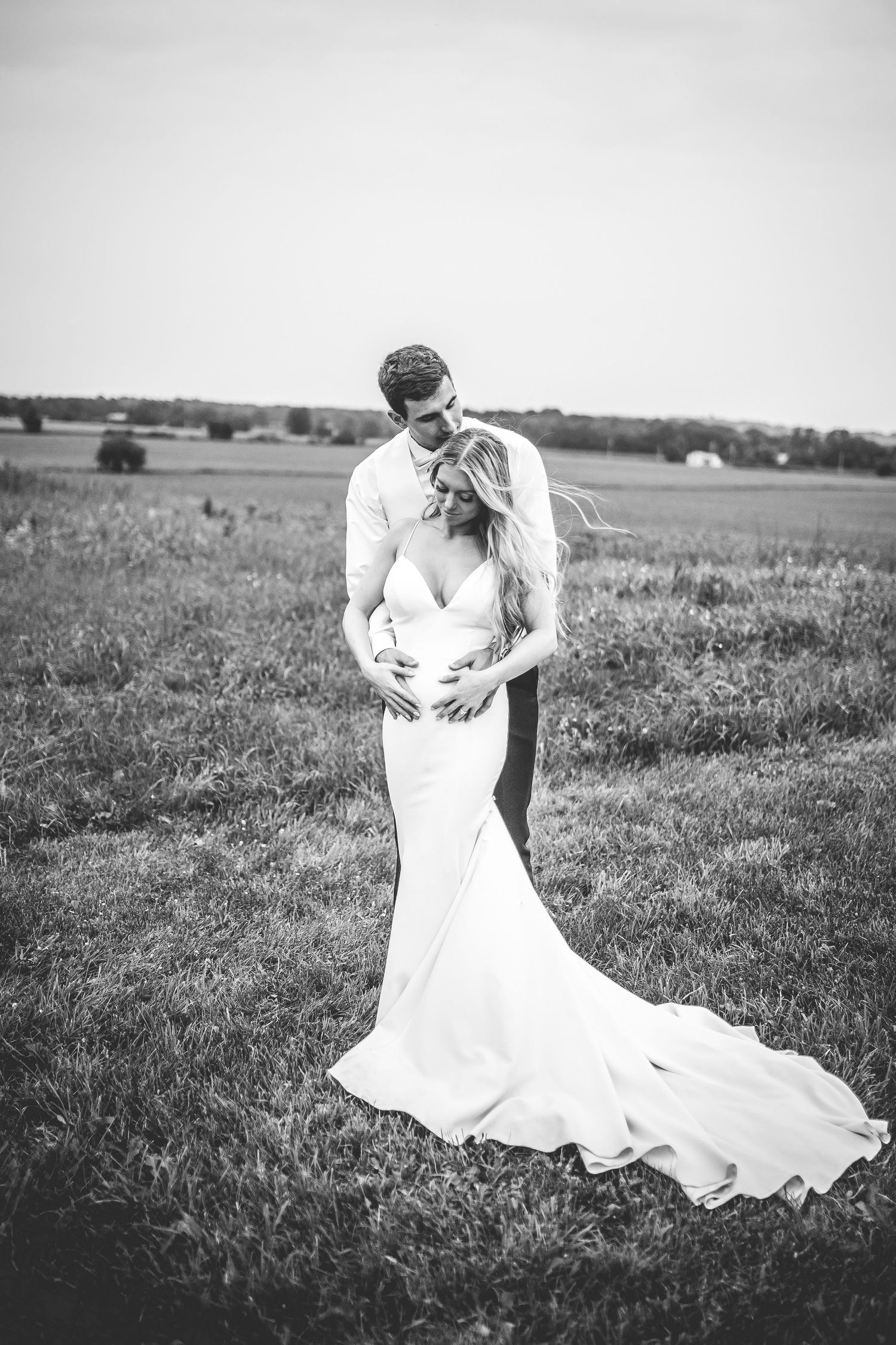 Black and white wedding portraits showing intimate moments in a rural setting.