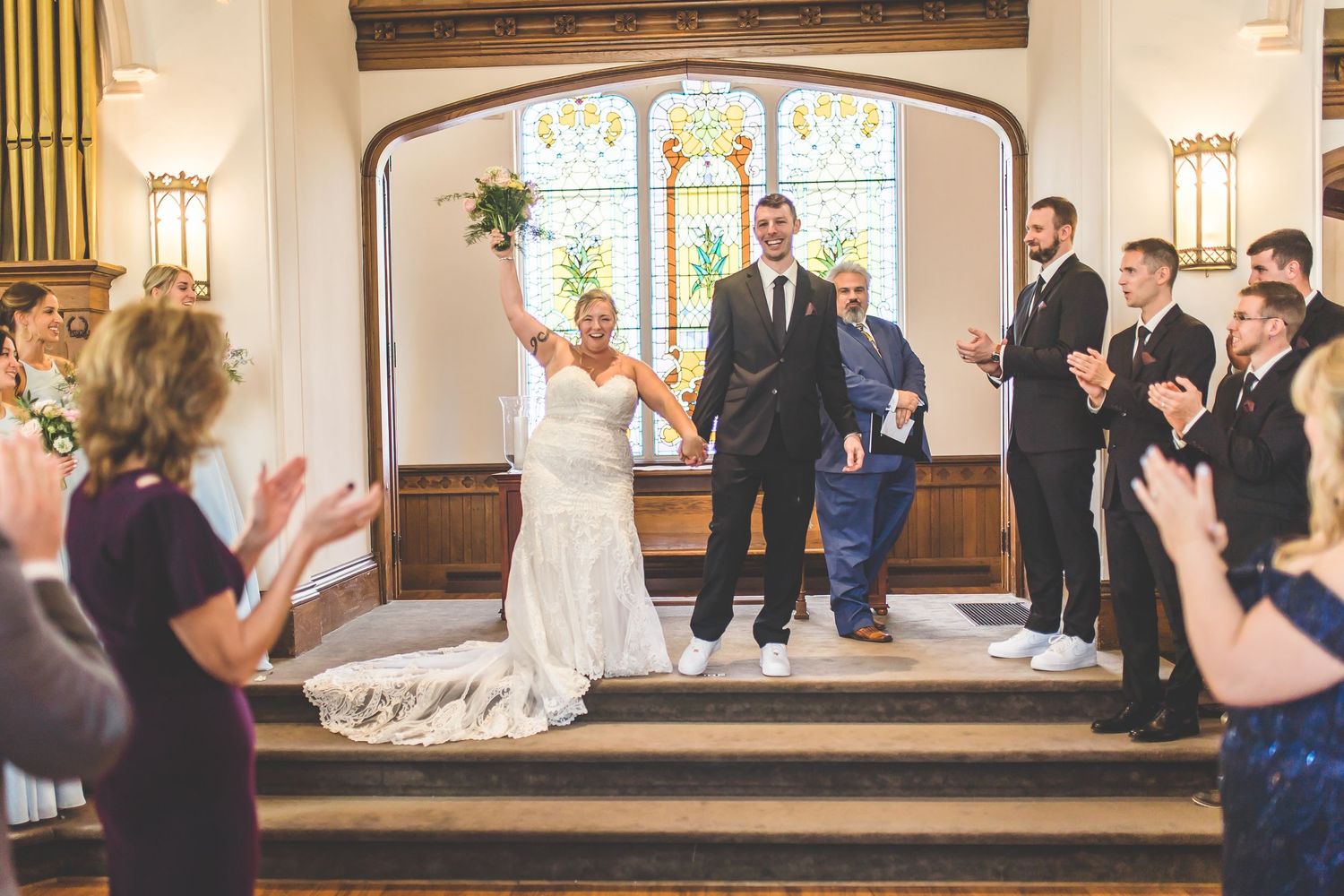 Panoramic view of a church wedding ceremony with guests watching the celebration unfold.