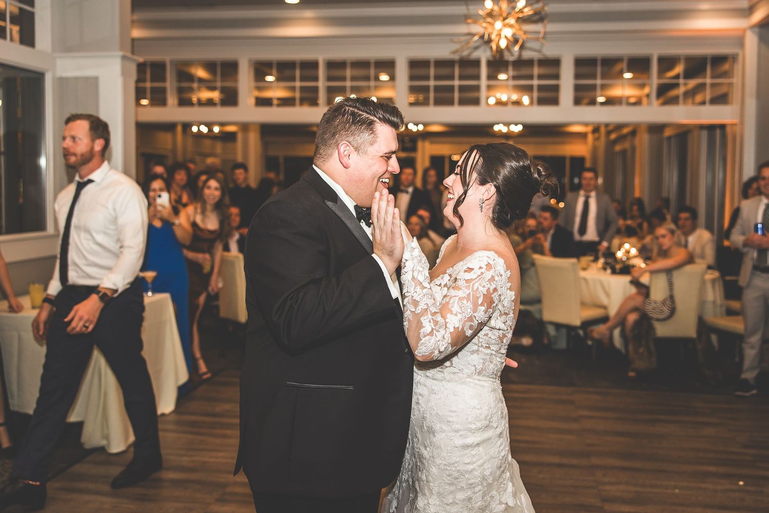 Elegant wedding reception venue with large windows and warm lighting.
