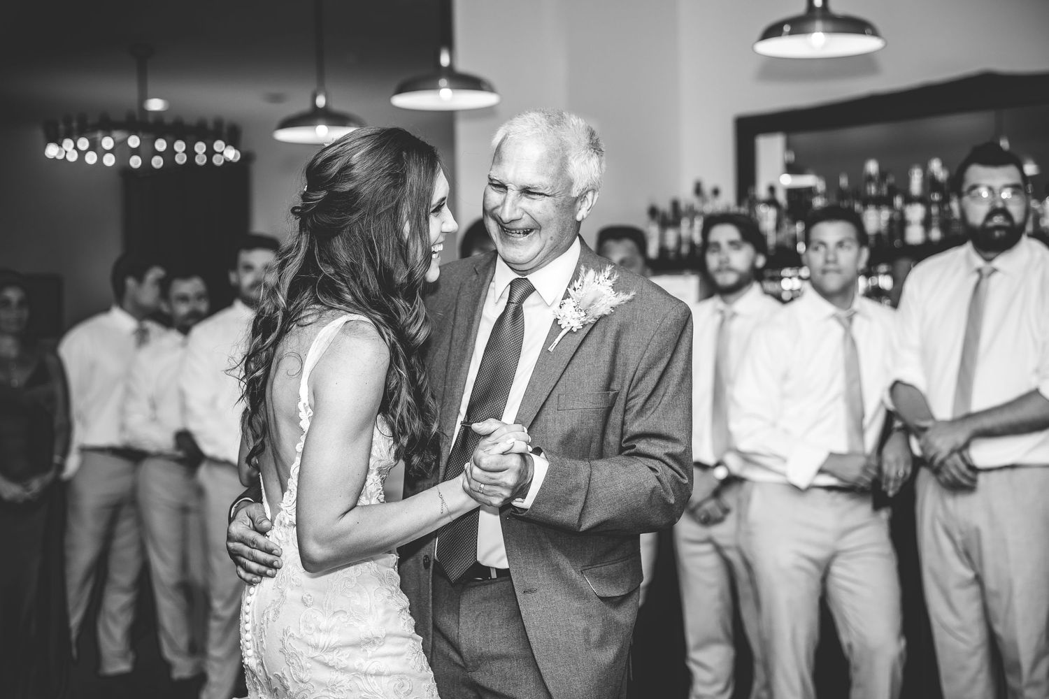 Wedding guests dancing and socializing during a lively reception celebration.