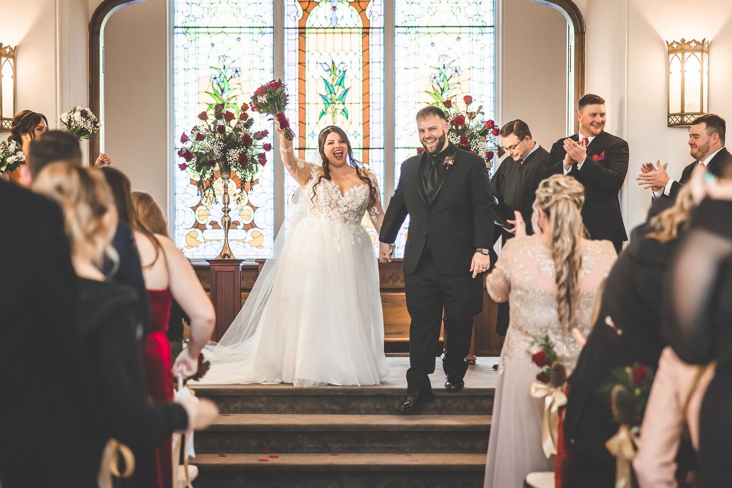 Wedding celebration in a historic church with ornate architecture and warm lighting.