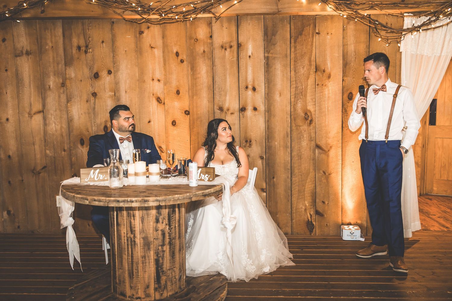 Romantic dance sequence captured in a rustic wooden barn with elegant lighting and decor.