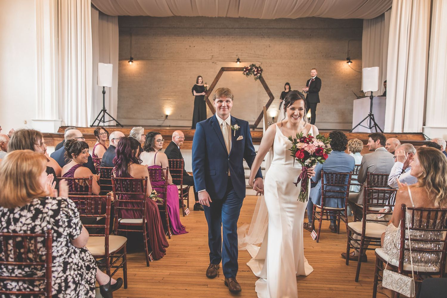 Wedding venue interior showing ceremony setup with rows of chairs and decorative architectural details.