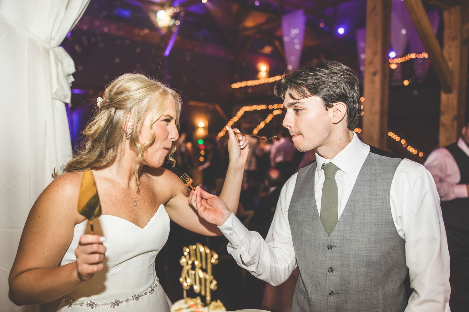 Wedding reception dance floor with purple mood lighting and festive atmosphere.