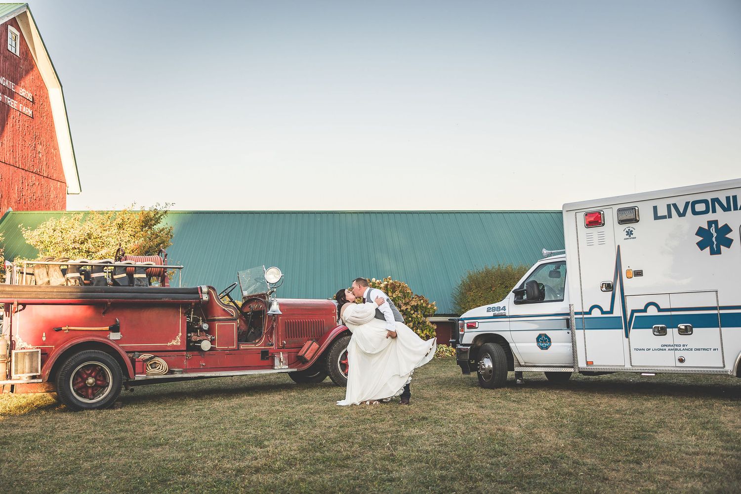 Emergency vehicles and ambulances lined up at an outdoor event.