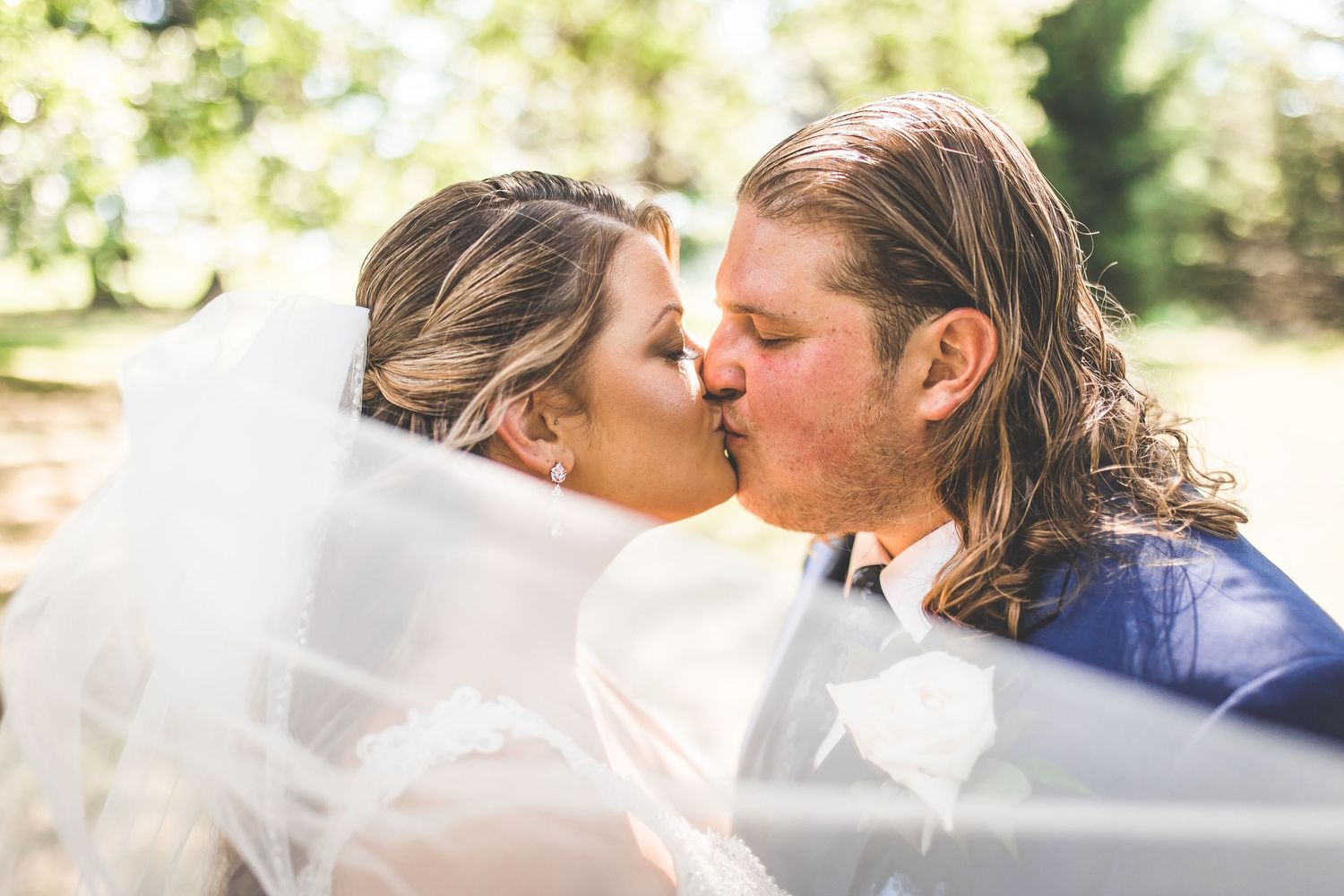 Sun-lit wedding portraits showing intimate moments between newlyweds.