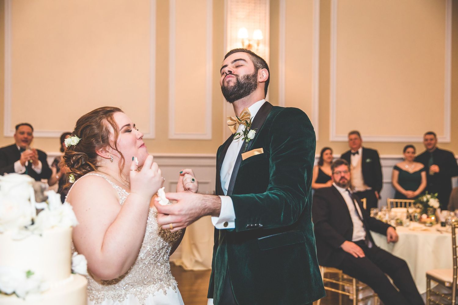 Wedding guests enjoying speeches and toasts during an elegant indoor reception.