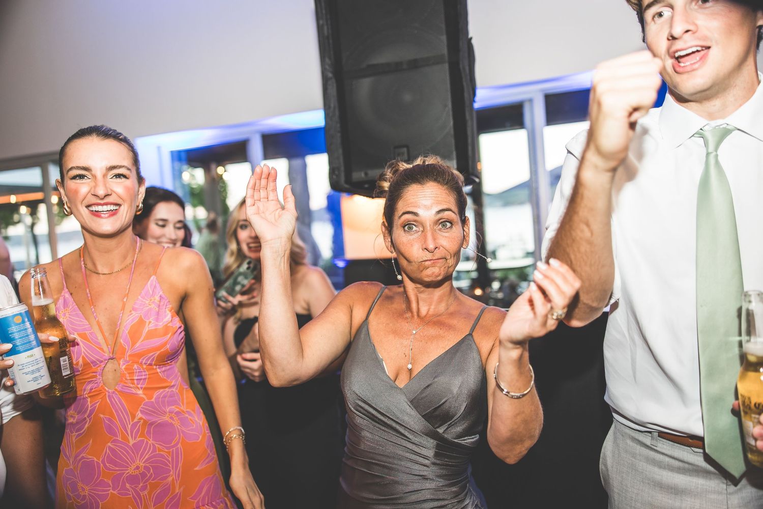 Wedding party guests dancing and celebrating with energetic moves.