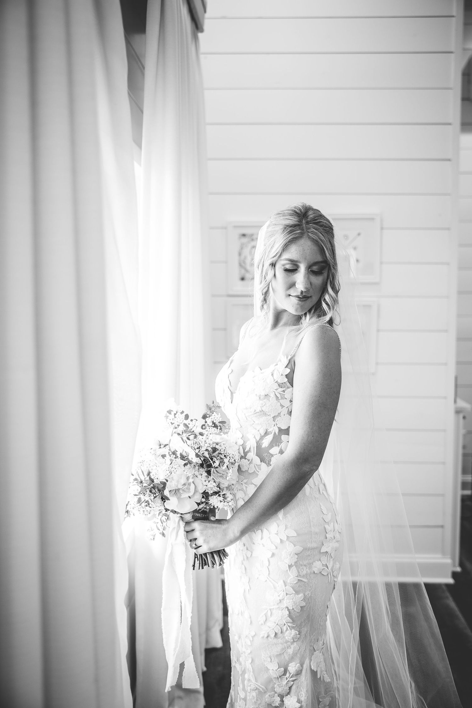 Black and white bridal portraits highlighting the intricate details of a lace wedding gown.
