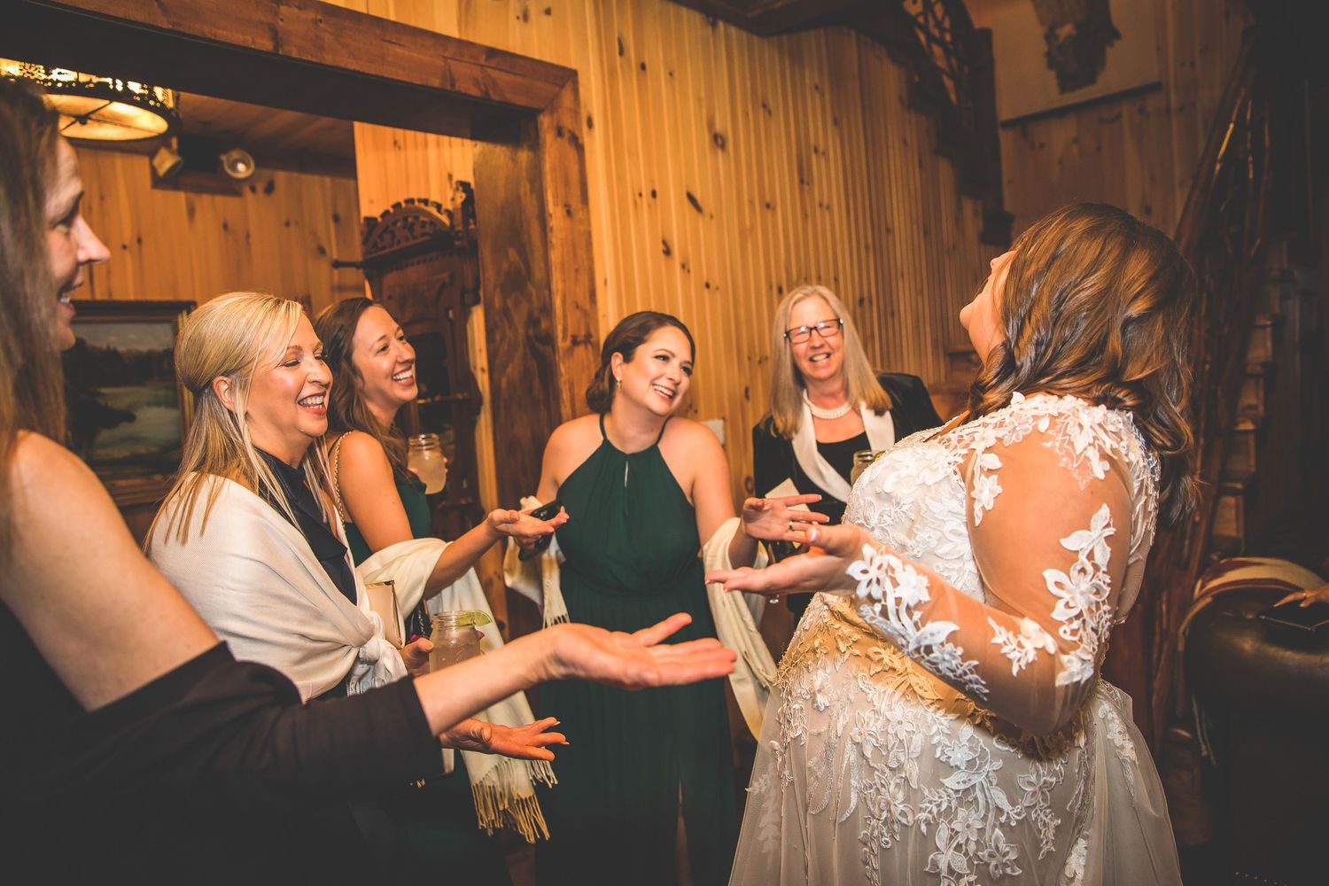 Wedding reception dance floor filled with guests celebrating under warm lighting.