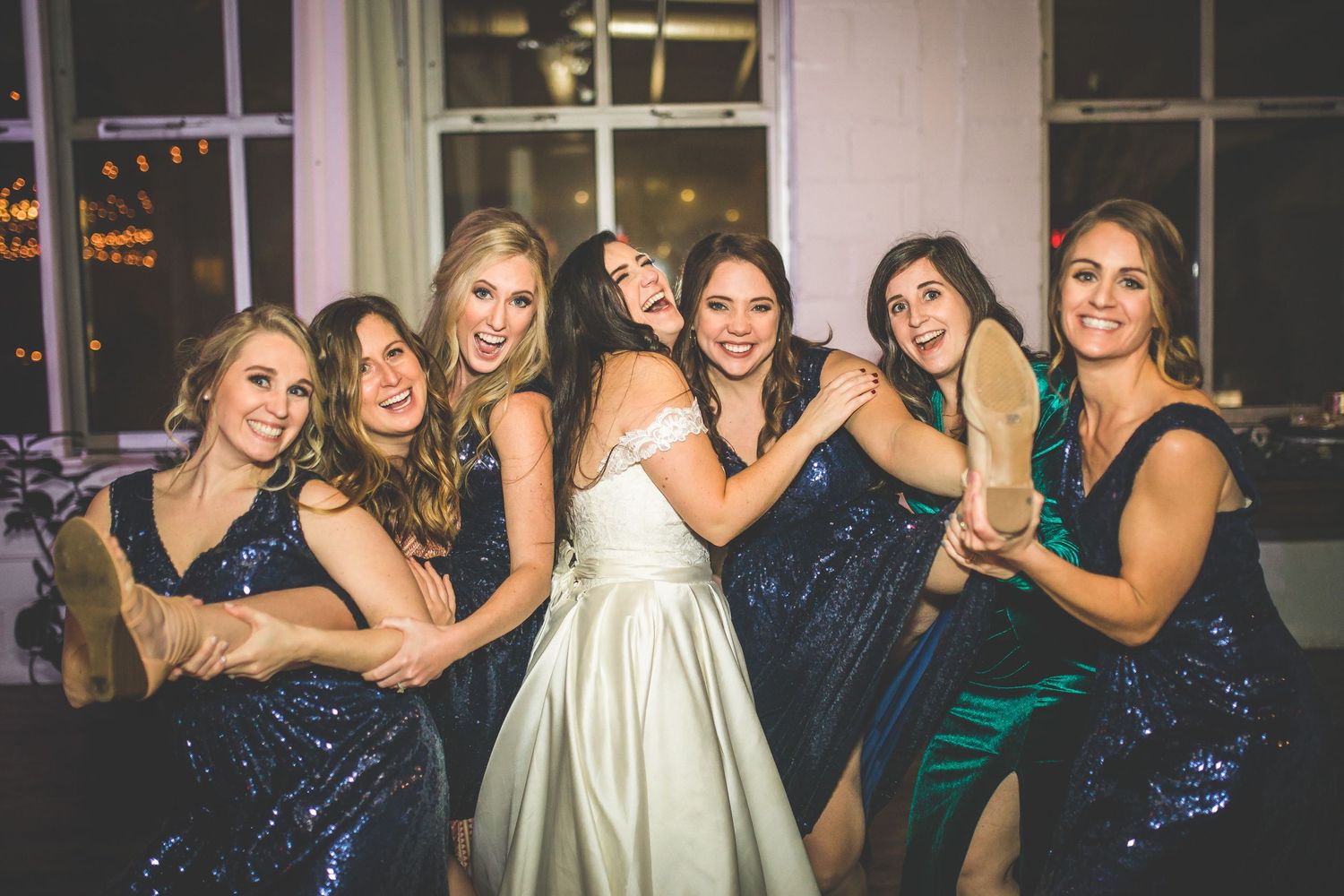 Wedding party group photos with bridesmaids in navy dresses posing together.