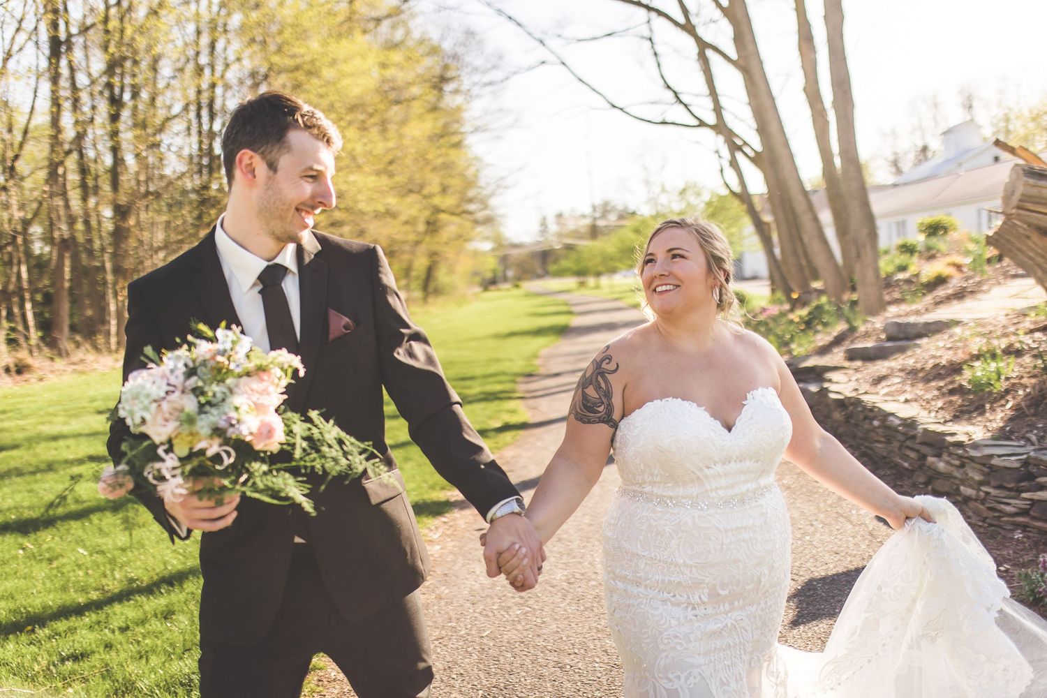 Candid wedding photo sequence shows couple laughing and embracing on tree-lined path.
