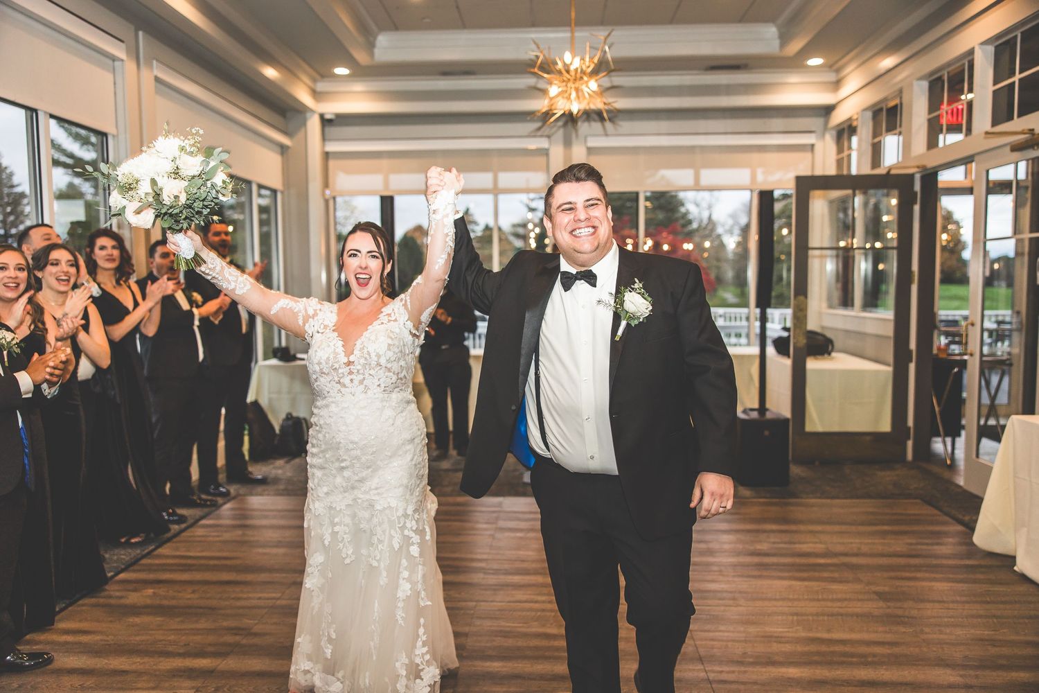Wedding guests line the dance floor watching a celebratory dance performance.